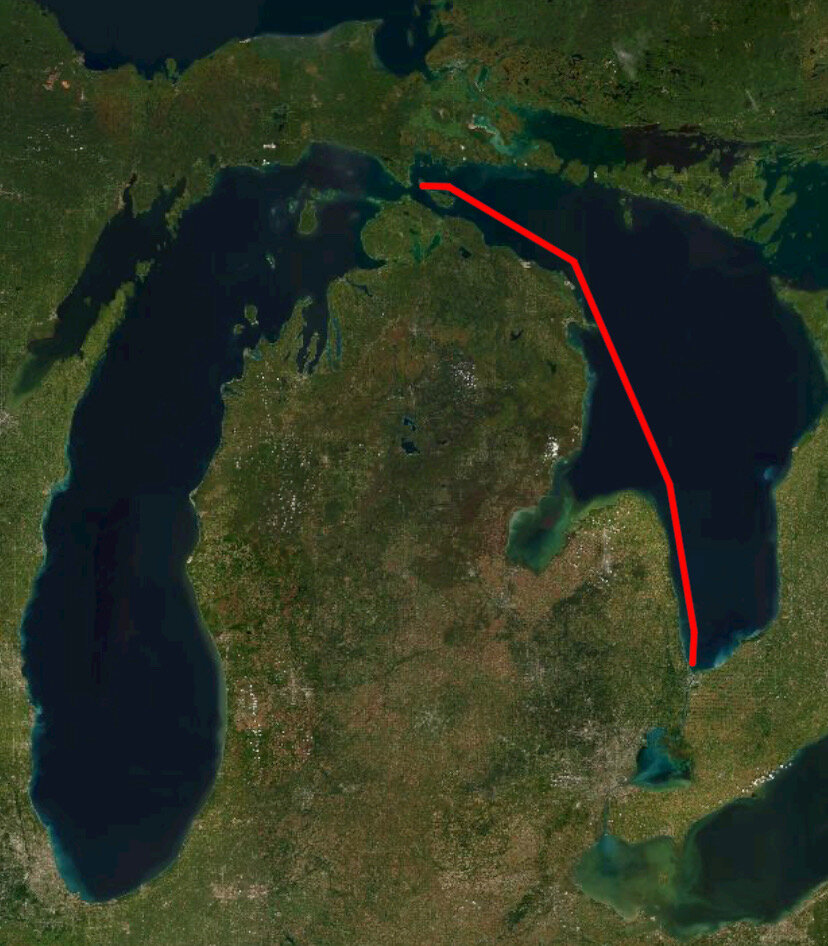 The red line is the Rhumb line: the shortest distance between two points.